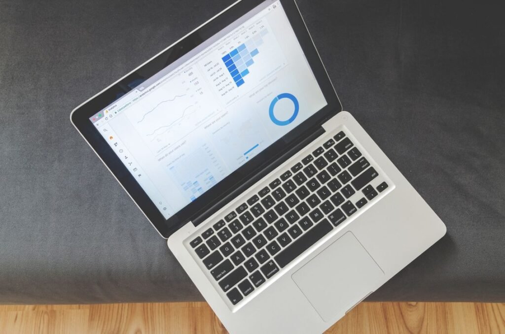 Overhead view of a laptop displaying analytics charts and dashboards, illustrating third-party measurement for ChatGPT Ads.