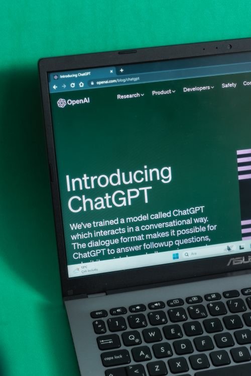 Laptop screen showing the Introducing ChatGPT page on OpenAI's website, the platform now testing visual ads.