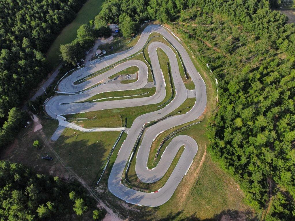 Aerial view of a winding race track with sweeping curves, illustrating how McDonald's spotted arch-shaped corners from above in the Golden Zone campaign