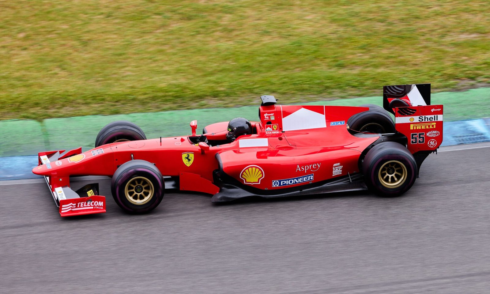 Red Formula 1 car speeding on a race track with motion blur, illustrating McDonald's entry into Formula 1 marketing