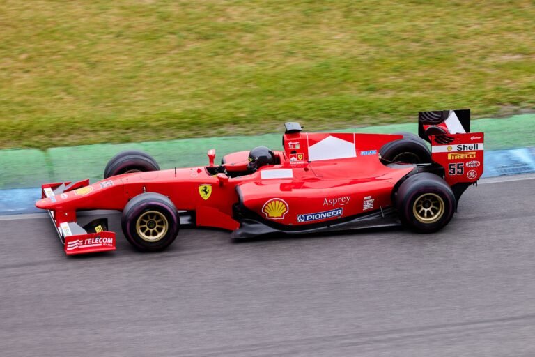 Red Formula 1 car speeding on a race track with motion blur, illustrating McDonald's entry into Formula 1 marketing